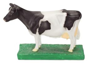Close-up of lifelike mini cow trophy model with realistic markings