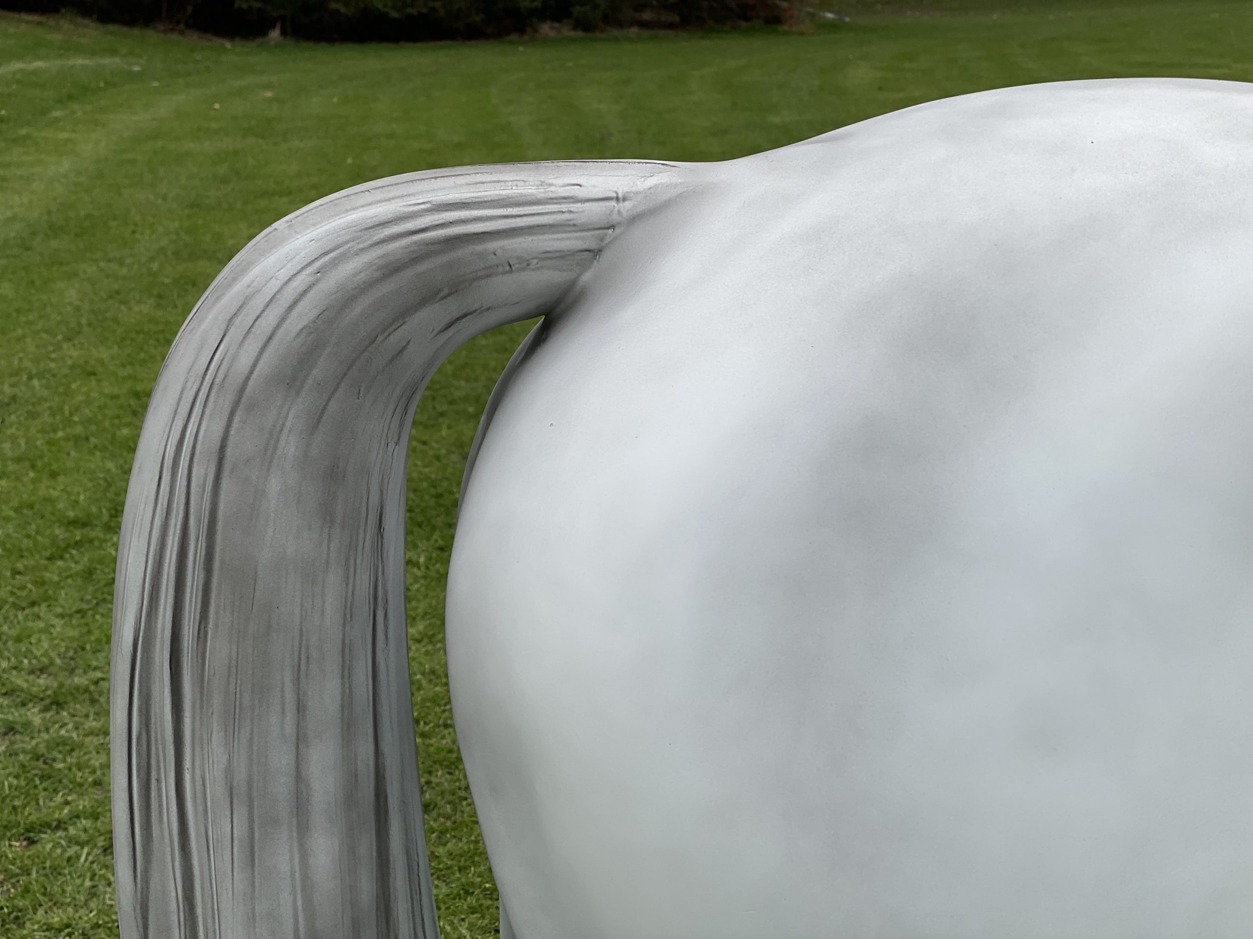 Hindquarters of a grey life‑size fibreglass riding pony model standing in a natural pose.